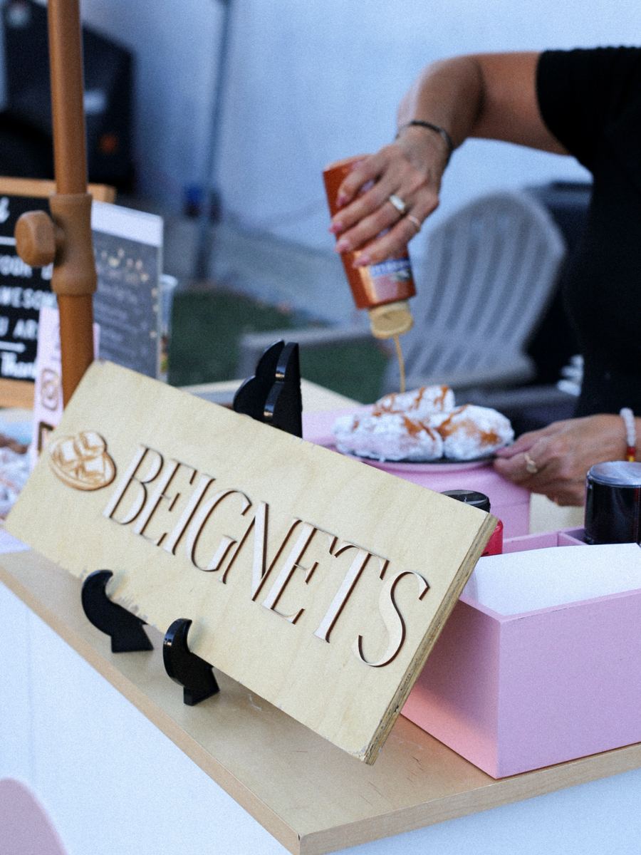 Beignets being served at a catering table